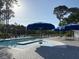 Community pool with umbrellas and lounge chairs, surrounded by lush greenery and a paved deck for ultimate relaxation at 255 Oak Point Landing Dr, Mount Pleasant, SC 29464