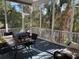 Relaxing screened-in porch with plenty of seating and a gas grill with views of the surrounding greenery at 255 Oak Point Landing Dr, Mount Pleasant, SC 29464