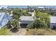 Beautiful aerial view of a coastal home, surrounded by lush palm trees and showcasing its proximity to the beach at 2604 Palmetto Blvd, Edisto Island, SC 29438