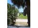 Exterior view of a backyard featuring green grass and a distant view of the beach at 2604 Palmetto Blvd, Edisto Island, SC 29438