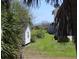 A backyard view through palm trees shows the beach nearby at 2604 Palmetto Blvd, Edisto Island, SC 29438