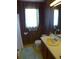 Modest bathroom featuring a window, single sink, and toilet, perfect for basic needs at 2604 Palmetto Blvd, Edisto Island, SC 29438