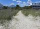 Sandy path to the beach with a picket fence at 2604 Palmetto Blvd, Edisto Island, SC 29438
