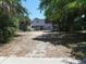 Exterior view of a charming beach home surrounded by lush trees, offering a private and serene setting at 2604 Palmetto Blvd, Edisto Island, SC 29438