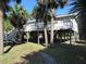 Exterior of the home showing large deck and pilings at 2604 Palmetto Blvd, Edisto Island, SC 29438