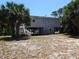 Charming beach home on stilts, surrounded by lush greenery and mature palm trees at 2604 Palmetto Blvd, Edisto Island, SC 29438