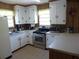 Well-lit kitchen featuring white cabinets and modern appliances at 2604 Palmetto Blvd, Edisto Island, SC 29438