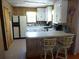 Classic kitchen featuring white cabinets, a breakfast bar, and tiled floors at 2604 Palmetto Blvd, Edisto Island, SC 29438