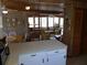 Inviting living room with wood paneling, ceiling fan, dining area, and neutral-toned furnishings at 2604 Palmetto Blvd, Edisto Island, SC 29438