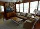 Relaxing living room featuring wooden walls, a TV, built-in bookshelves, and cozy seating at 2604 Palmetto Blvd, Edisto Island, SC 29438