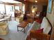 Comfortable living room featuring wooden walls, multiple seating options, and a wooden coffee table at 2604 Palmetto Blvd, Edisto Island, SC 29438