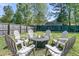 This fenced backyard features an outdoor fire pit with six Adirondack chairs for entertaining at 2809 Conservancy Ln, Charleston, SC 29414