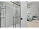 Modern bathroom featuring a glass-enclosed shower and access to the bedroom with soft, natural light at 2809 Conservancy Ln, Charleston, SC 29414