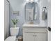 This bathroom has a pedestal sink with decorative fixtures and a large vanity mirror at 2809 Conservancy Ln, Charleston, SC 29414