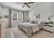Comfortable bedroom features a large window with blinds, soft lighting, and neutral decor for a relaxing space at 2809 Conservancy Ln, Charleston, SC 29414