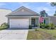 Charming single-story home with a two-car garage, well-manicured lawn and an American flag at 2809 Conservancy Ln, Charleston, SC 29414