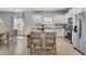 Bright kitchen with white cabinets, stainless steel appliances, and a granite-topped island with seating at 2809 Conservancy Ln, Charleston, SC 29414