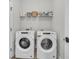 Neat laundry room with two front load washers and a storage shelf at 2809 Conservancy Ln, Charleston, SC 29414
