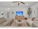 Bright living room featuring a ceiling fan, a sectional sofa, and a wooden media center at 2809 Conservancy Ln, Charleston, SC 29414