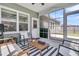 Relaxing screened-in porch with modern seating and views of the backyard at 2809 Conservancy Ln, Charleston, SC 29414