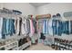 Organized walk-in closet featuring shelves for shoes, rods for hanging clothes, and ample storage space at 2809 Conservancy Ln, Charleston, SC 29414