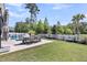 A serene backyard retreat featuring a dining area, lush green lawn, and a pool at 2827 Wagner Way, Mount Pleasant, SC 29466