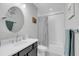 Contemporary bathroom with sleek vanity, round mirror, and stylish striped shower curtain at 2827 Wagner Way, Mount Pleasant, SC 29466