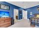 Blue bedroom with a TV, dresser and adjoining space that features a wet bar at 2827 Wagner Way, Mount Pleasant, SC 29466