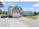 Charming two-story house featuring a well-kept lawn, inviting front porch, and an attached two-car garage at 2827 Wagner Way, Mount Pleasant, SC 29466