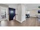 Upstairs hallway with wood floors, white trim, and accent wall leading to additional bedrooms and game room at 2827 Wagner Way, Mount Pleasant, SC 29466