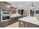 Modern kitchen featuring stainless steel appliances, a large island, and dark wood cabinetry at 2827 Wagner Way, Mount Pleasant, SC 29466