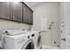 Functional laundry room with front-load washer/dryer and dark wood cabinets at 2827 Wagner Way, Mount Pleasant, SC 29466