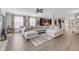 Spacious living room features a large sectional sofa, wood floors, and many windows at 2827 Wagner Way, Mount Pleasant, SC 29466