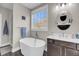 Bright main bathroom featuring a freestanding tub, vanity, and window at 2827 Wagner Way, Mount Pleasant, SC 29466