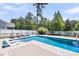 Stunning backyard pool with in-pool lounge chairs and a meticulously landscaped yard at 2827 Wagner Way, Mount Pleasant, SC 29466