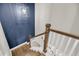 Elegant staircase featuring hardwood steps, white railing, and a modern light fixture at 2827 Wagner Way, Mount Pleasant, SC 29466
