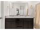 Double vanity bathroom with a large mirror, dark cabinetry and neutral accents at 314 Beverly Dr, Ladson, SC 29456