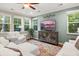 Bright living room with large windows, a modern TV, and comfortable seating at 314 Beverly Dr, Ladson, SC 29456