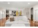 Spacious living room with hardwood floors, white sofa, and open view of the kitchen at 314 Beverly Dr, Ladson, SC 29456