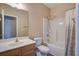 Bathroom with updated shower head, tile surround, and white vanity with mirror at 317 Pimpernel St, Summerville, SC 29483