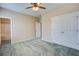 This neutral bedroom features a ceiling fan, plush carpet, and a double door closet at 317 Pimpernel St, Summerville, SC 29483