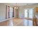 Bright dining area featuring hardwood floors, large windows, and glass doors that let in plenty of natural light at 317 Pimpernel St, Summerville, SC 29483