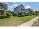 Charming two-story home with a well-manicured lawn and inviting front porch in a suburban neighborhood at 317 Pimpernel St, Summerville, SC 29483