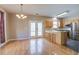 Open kitchen and dining area with wooden floors, an island with seating, and stainless steel appliances at 317 Pimpernel St, Summerville, SC 29483