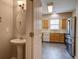 Kitchen view with pedestal sink, open door, stainless steel refrigerator and a glimpse of the countertop at 317 Pimpernel St, Summerville, SC 29483