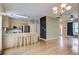 Spacious kitchen with an island bar, stainless steel appliances, and adjoining living area with wood floors at 317 Pimpernel St, Summerville, SC 29483