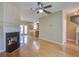 Spacious living room with hardwood floors, fireplace, ceiling fan, dining area and kitchen at 317 Pimpernel St, Summerville, SC 29483