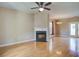Spacious living room with hardwood floors, fireplace, ceiling fan, and a dining area at 317 Pimpernel St, Summerville, SC 29483
