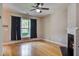 Cozy living room with hardwood floors, fireplace, ceiling fan, and a window with curtains at 317 Pimpernel St, Summerville, SC 29483