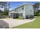 Home's backyard featuring an enclosed porch, a well manicured lawn and driveway at 3191 Moonlight Dr, Charleston, SC 29414
